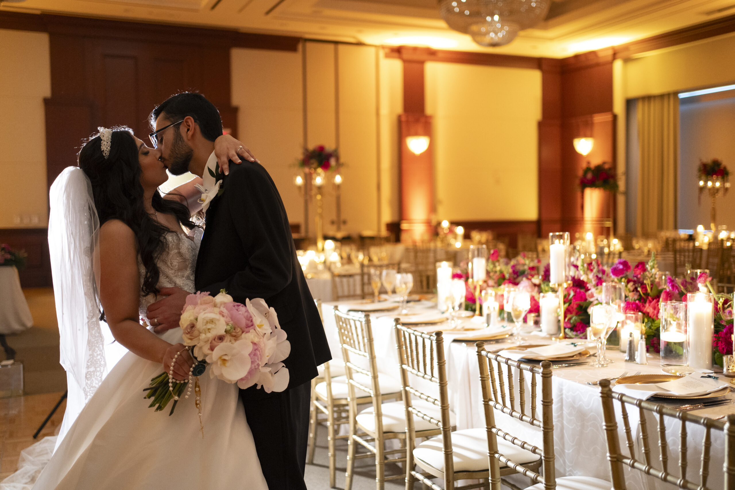 Couple kissing during their ballroom reveal at intercontinental hotel in cleveland ohio