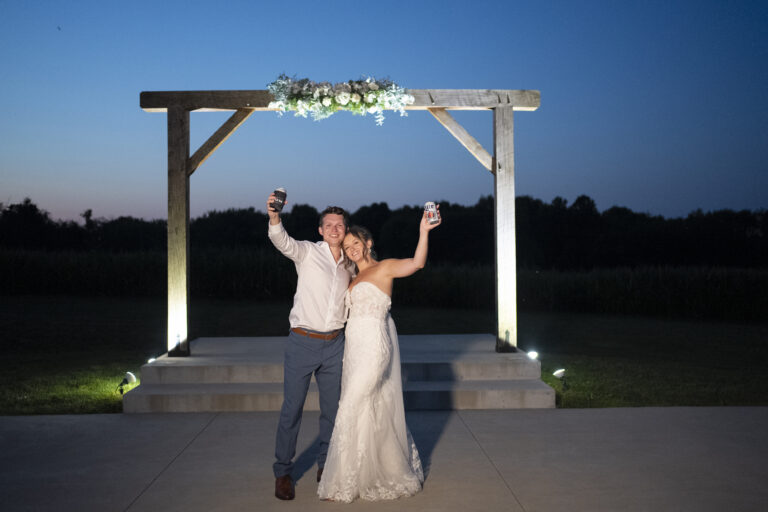 Bride & Groom at blue hour holding drinks at Birdseye Barn.