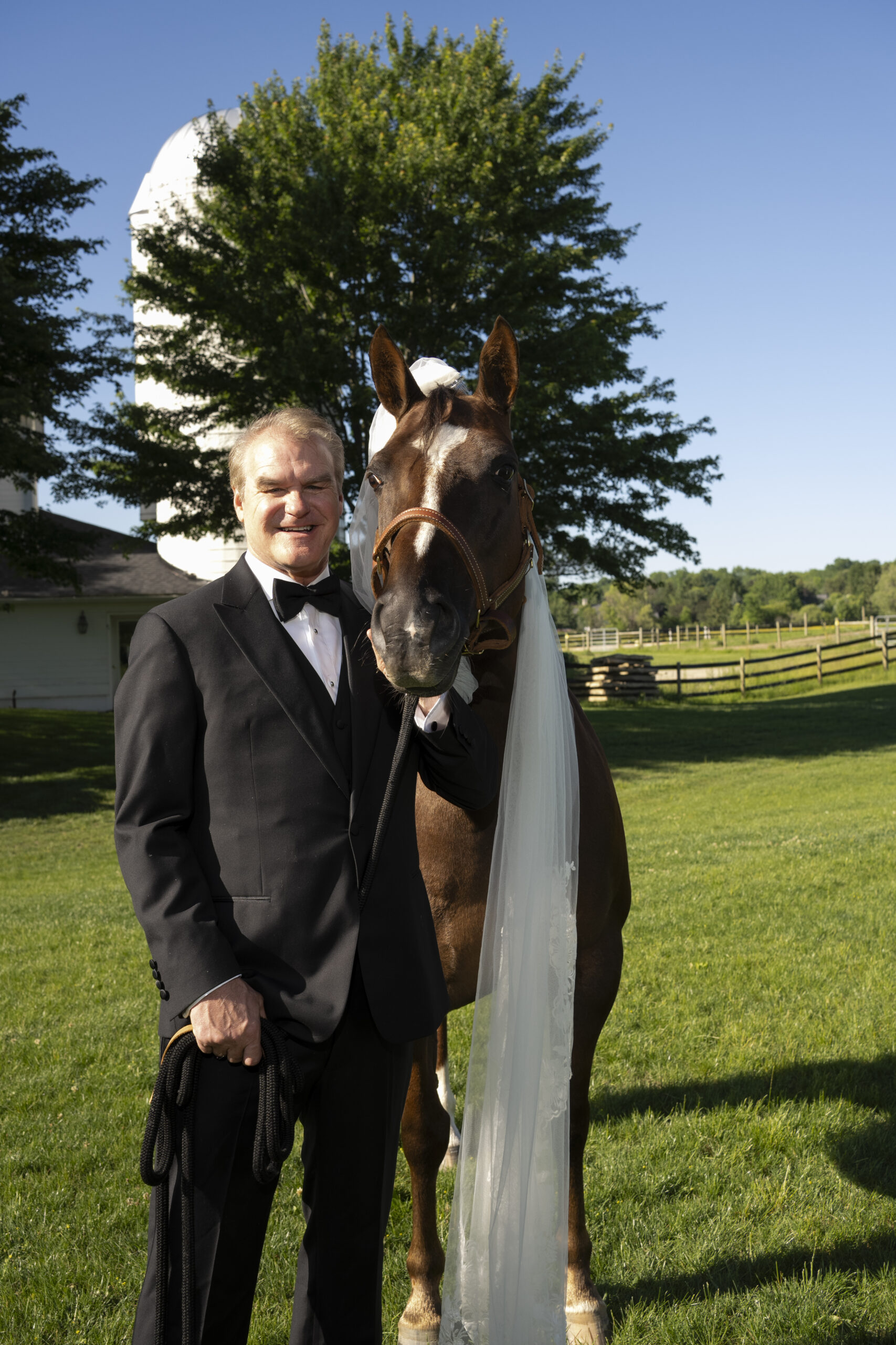 Groom with a horse wearing a veil outside Walden Inn