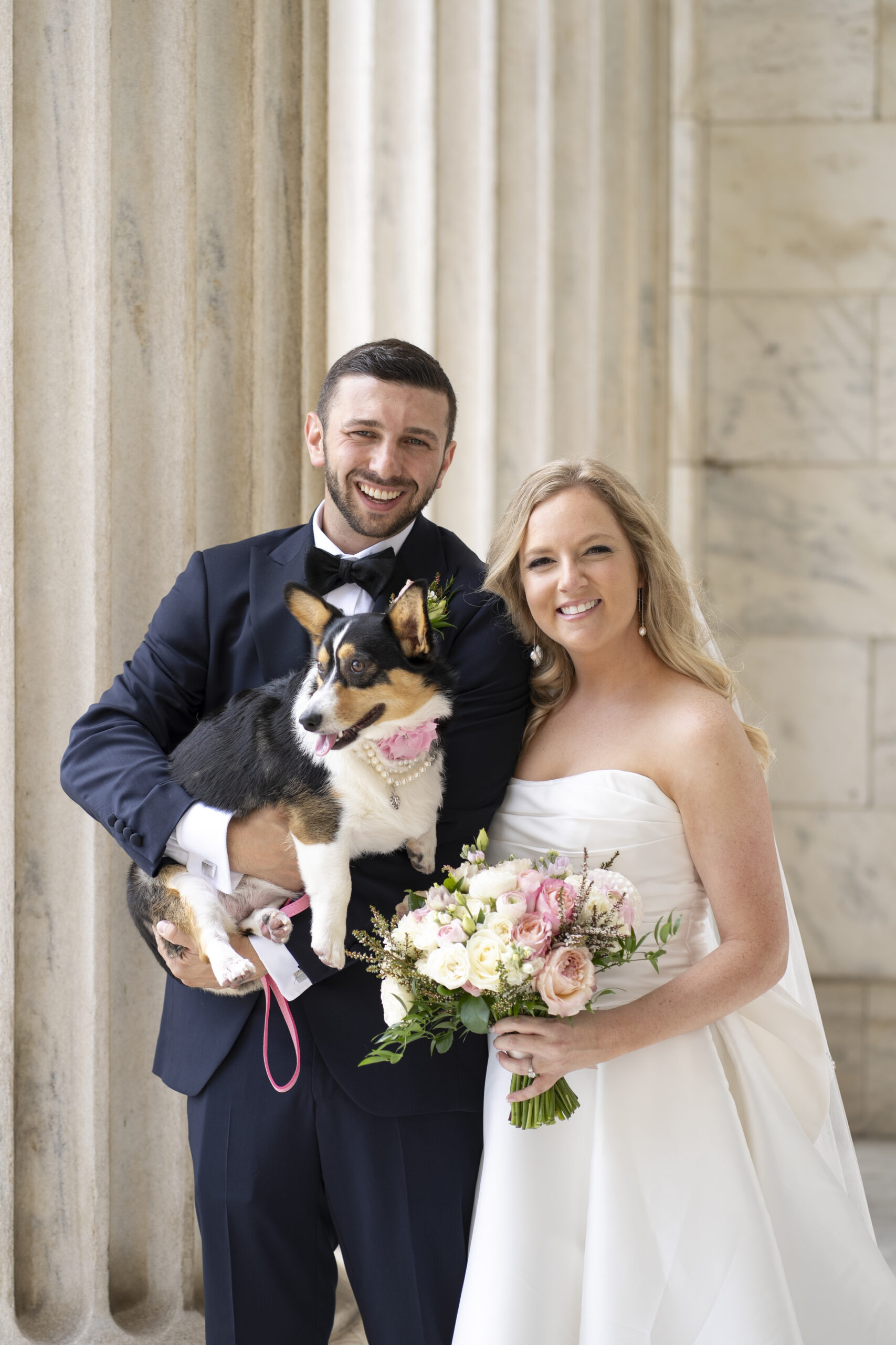 Bride and Groom holding their Corgi at Cleveland Museum of Art.